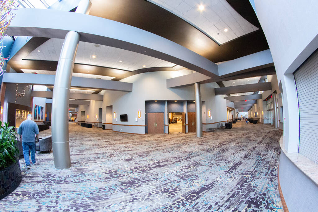 The seating area and corridor leading back to the hotel on the left registration office with the right to the seminars room